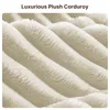 A close-up view of a textured fabric, likely a sofa or blanket, with diagonal ridges and a plush surface. Náhled obrázku produktu