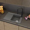 A modern kitchen sink with a faucet and accessories on a countertop. Podgląd zdjęcia produktu