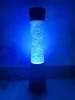 A tall, cylindrical lamp with blue, bubbly light is shown against a dark blue background. Anteprima dell’immagine prodotto