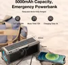 A portable speaker is shown charging a smartphone, with a bag in the background. Podgląd zdjęcia produktu