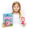 A young girl is holding a magnetic board game and a magnetic doll. Produktbild-Vorschau