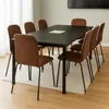 A dining table with chairs in a room. Produktbild-Vorschau