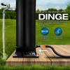 A black solar shower is shown outdoors on a wooden deck, with water flowing from a tap. Produktbild-Vorschau