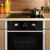 A close-up view of a modern kitchen oven and induction hob. Produktbild-Vorschau