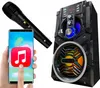 A hand holding a smartphone with a music app icon, a microphone, and a Bluetooth speaker. Produktbild-Vorschau