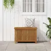 A wooden storage box with a pillow on top, placed on a tiled patio in front of a white wooden wall with a window. Náhľad obrázku produktu