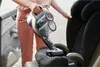A person is cleaning a car seat with a cordless vacuum cleaner. Produktbild-Vorschau