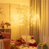 A decorated room with Christmas decorations, including a lit tree, presents, and Santa figures. Anteprima dell’immagine prodotto