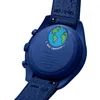 The back of a blue Swatch x Omega watch with the Earth depicted on it. Produktbild-Vorschau