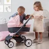 Two children playing with a toy stroller indoors. Produktbild-Vorschau