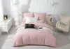 A neatly made bed with pink bedding and decorative pillows in a bright room. Podgląd zdjęcia produktu