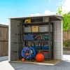 An open storage shed filled with various tools and equipment, set up outdoors on a wooden deck. Anteprima dell’immagine prodotto