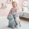A young child is happily riding a gray inflatable unicorn toy in a nursery or playroom. Anteprima dell’immagine prodotto