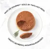 A close-up of cat food on a white plate with a sprig of dill. Podgląd zdjęcia produktu