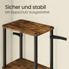 A close-up view of a shelf unit with a rustic wood finish and black metal legs, showing anti-tip straps attached to the wall. Produktbild-Vorschau