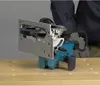 A circular saw is placed on a wooden workbench. Anteprima dell’immagine prodotto