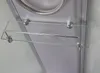 A close-up view of a glass shelf with a metal rail, mounted inside a shower cabin. Produktbild-Vorschau