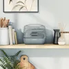 A Kenwood hand mixer is displayed on a shelf with other decorative items. Podgląd zdjęcia produktu