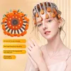 A woman wearing a head massager, with a separate image of the head massager device. Text overlays describe features. Produktbild-Vorschau
