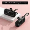 Two black portable power banks are displayed on a pink and white surface. Produktbild-Vorschau