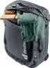 A close-up view of a gray duffel bag with its main compartment partially open, revealing folded green clothing, a brown notebook, and a wooden board. A combination lock is attached to the zipper. Produktbild-Vorschau
