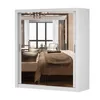 A white wardrobe with mirrored doors reflecting a bedroom interior. Náhľad obrázku produktu