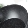 A close-up view of the speckled interior of a black frying pan. Náhled obrázku produktu
