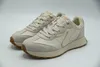 A pair of beige Skechers sneakers on a white background. Produktbild-Vorschau