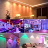 Collage of different interior lighting scenes, showcasing LED spotlights and strip lights in various colors and room settings. Produktbild-Vorschau