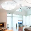 A modern living room with a fireplace, TV, and large windows with sheer curtains. Produktbild-Vorschau