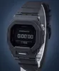 A black Casio G-Shock watch is displayed on a stand against a blue background. Podgląd zdjęcia produktu