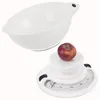 A white mixing bowl is placed above a white mechanical kitchen scale with an apple on it. Produktbild-Vorschau