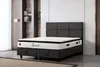 A bed with a mattress in a room. Produktbild-Vorschau