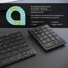 A marketing image showing two black wireless numeric keypads on a dark surface, with overlaid text describing features and compatibility. Náhled obrázku produktu