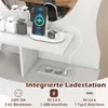 A close-up view of a vanity table's integrated charging station, featuring a phone and smartwatch charging, along with electrical outlets and USB ports. Podgląd zdjęcia produktu
