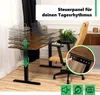 A height-adjustable desk in a home office setting, with a chair and some office supplies. Produktbild-Vorschau