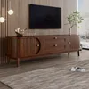 A modern living room with a TV stand, TV, and decorative items. Voir les images du produit