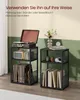 Two black metal shelving units are shown in a room. The left unit holds a record player, a speaker, and vinyl records. The right unit holds books, headphones, and decorative items. Produktbild-Vorschau
