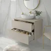 A bathroom vanity with two drawers, a sink, and a faucet, set against a marble-tiled wall. Náhled obrázku produktu