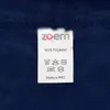 A close-up of a clothing label attached to a dark blue fleece fabric. Produktbild-Vorschau