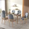 A dining room set with a glass-top table and six chairs. Produktbild-Vorschau