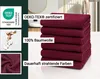 A stack of burgundy towels with certifications and material information displayed on the left and overlaid on the image. Produktbild-Vorschau