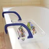A drying rack with colorful items hanging on it, placed over the edge of a bathtub. Náhled obrázku produktu