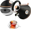 A black electric kettle with copper accents is pouring hot water into a glass teacup. An inset shows a close-up of the kettle's base. Voir les images du produit