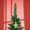 The top part of a green artificial Christmas tree with a gold star ornament hanging from it, against a coral-colored background with shadows. Produktbild-Vorschau