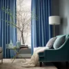 A cozy living room scene with blue curtains, a teal chaise lounge, and a small side table. Produktbild-Vorschau