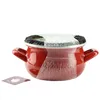 A red enamel pot with a lid and a tea bag tag. Produktbild-Vorschau