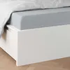 A close-up view of a bed with a gray fitted sheet and white duvet. Produktbild-Vorschau