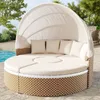 A round outdoor daybed with a canopy and cushions, situated on a patio next to a swimming pool. Voir les images du produit