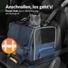 A cat is sitting in a blue pet carrier that is secured with a car seatbelt in a car. Anteprima dell’immagine prodotto